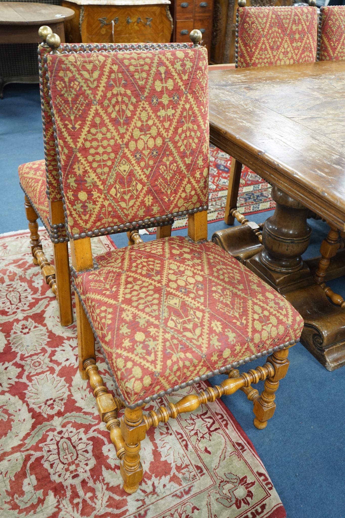 A set of twelve 18th century style French walnut dining chairs on turned underframes with H stretchers